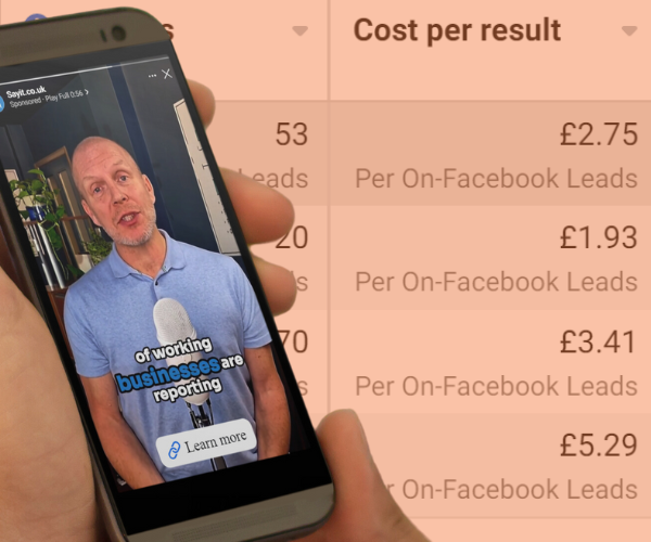 A hand holding a mobile phone with an advertising video on the screen, with results from an ad campaign run by the Upscale Ads team showing behind the hand.