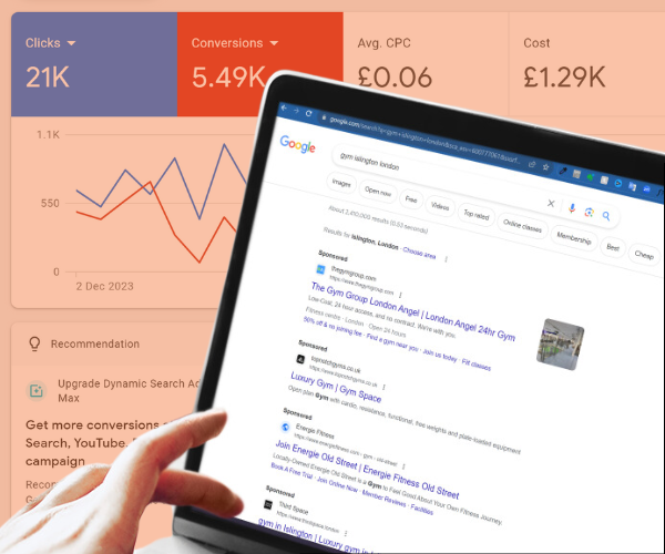 A hand tapping a button on a laptop with the laptop screen showing Google Search results. Behind the laptop, you can see positive Google Ads results from a campaign run by Upscale Ads.